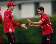 2 May 2024; Jordan Neil of Munster Reds celebrates with teammate Curtis Campher after catching out Neil Rock of Northern Knights during the Cricket Ireland Inter-Provincial Trophy match between Munster Reds and Northern Knights at Pembroke Cricket Club in Dublin. Photo by Harry Murphy/Sportsfile