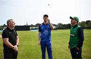 2 May 2024; George Dockrell of Leinster Lightning tosses the coin watched by Match referee Graham McCrea and Andy McBrine of North West Warriors before the Cricket Ireland Inter-Provincial Trophy match between Leinster Lightning and North West Warriors at Pembroke Cricket Club in Dublin. Photo by Harry Murphy/Sportsfile