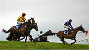 2 May 2024; Singing Banjo, left, with Barry Walsh up, jumps Ruby's Double on their way to winning the Mongey Communications La Touche Cup Cross Country Steeplechase during day three of the Punchestown Festival at Punchestown Racecourse in Kildare. Photo by Seb Daly/Sportsfile