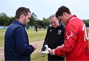 3 May 2024; Umpire Graham McCrea with team captains PJ Moor of Munster Reds, right, and Andy McBrine of North West Warriors for the coin toss before the Cricket Ireland Inter-Provincial Trophy match between North West Warriors and Munster Reds at Pembroke Cricket Club in Dublin. Photo by Piaras Ó Mídheach/Sportsfile
