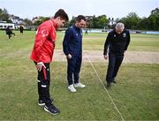 3 May 2024; Umpire Graham McCrea with team captains PJ Moor of Munster Reds, left, and Andy McBrine of North West Warriors for the coin toss before the Cricket Ireland Inter-Provincial Trophy match between North West Warriors and Munster Reds at Pembroke Cricket Club in Dublin. Photo by Piaras Ó Mídheach/Sportsfile