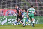 3 May 2024; Filip Piszczek of Bohemians shoots to score his side's first goal past Shamrock Rovers goalkeeper Leon Pohls during the SSE Airtricity Men's Premier Division match between Bohemians and Shamrock Rovers at Dalymount Park in Dublin. Photo by Stephen McCarthy/Sportsfile