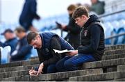 4 May 2024; Supporters study and take notes on their match programmes before the Connacht GAA Football U20 Championship final match between Roscommon and Galway at Hastings Insurance MacHale Park in Castlebar, Mayo. Photo by Ben McShane/Sportsfile