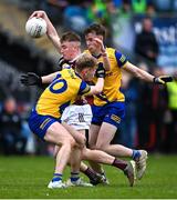 4 May 2024; Fionn Mac Donnacha of Galway is tackled by Robert Heneghan, left, and Conor Harley of Roscommon during the Connacht GAA Football U20 Championship final match between Roscommon and Galway at Hastings Insurance MacHale Park in Castlebar, Mayo. Photo by Ben McShane/Sportsfile