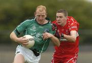 24 July 2004; John Quane, Limerick, is tackled by Derry's Jason Stokes. Bank of Ireland Senior Football Championship Qualifier, Round 4, Derry v Limerick, Dr. Hyde Park, Roscommon. Picture credit; Pat Murphy / SPORTSFILE