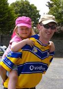 31 July 2004; Clare supporter Roisin Guerin, 4 years, is carried by her dad Vincent on her way to the match.   Guinness All-Ireland Hurling Championship Quarter Final Replay, Clare v Kilkenny, Semple Stadium, Thurles, Co. Tipperary. Picture credit; Ray McManus / SPORTSFILE