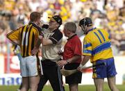 31 July 2004; The Kilkenny doctor Tadhg Crowley attends to Henry Shefflin as referee Pat Horan and Clares Gerry Quinn look on. Guinness All-Ireland Hurling Championship Quarter Final Replay, Clare v Kilkenny, Semple Stadium, Thurles, Co. Tipperary. Picture credit; Ray McManus / SPORTSFILE