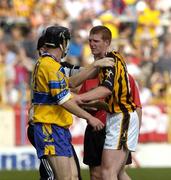 31 July 2004; The Kilkenny doctor Tadhg Crowley attends to Henry Shefflin as referee Pat Horan and Clare's Gerry Quinn look on. Guinness All-Ireland Hurling Championship Quarter Final Replay, Clare v Kilkenny, Semple Stadium, Thurles, Co. Tipperary. Picture credit; Ray McManus / SPORTSFILE