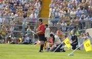 31 July 2004; Kilkenny's Henry Shefflin is treated for an eye injury by team doctor Tadhg Crowley as Barry Kelly, linesman, looks at the action. Guinness All-Ireland Hurling Championship Quarter Final Replay, Clare v Kilkenny, Semple Stadium, Thurles, Co. Tipperary. Picture credit; Brendan Moran / SPORTSFILE