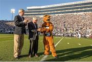 14 September 2013; Former US Ambassador to Ireland and Chairman of the Pittsburgh Steelers Dan Rooney, centre, joined Ard Stiúrthoir of the GAA Páraic Duffy and the Penn State University mascot, the Nittany Lion, on the pitch last night in Beaver Stadium, Pennsylvania, to officially launch the Croke Park Classic in the US. Duffy announced to the almost 100,000 strong audience of Penn State and UCF fans, that the winner of the Croke Park Classic would be presented with the Dan Rooney Trophy, named in honour of Rooney. Beaver Stadium, Penn State University, Pennsylvania, United States. Picture credit: Mark Selders / SPORTSFILE