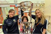 16 September 2013; Galway intermediate camogie captain Sinéad Keane, left, and Galway senior camogie captain Lorraine Ryan with Maura Williams, age 8, from Tuam, Co. Galway, and the O'Duffy Cup, top, and the Jack McGrath Cup on a visit by the All-Ireland Senior & Intermediate Camogie Champions to Our Lady's Children's Hospital, Crumlin. Picture credit: Stephen McCarthy / SPORTSFILE