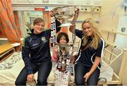 16 September 2013; Galway intermediate camogie captain Sinéad Keane, left, and Galway senior camogie captain Lorraine Ryan with Maura Williams, age 8, from Tuam, Co. Galway, and the O'Duffy Cup, top, and the Jack McGrath Cup on a visit by the All-Ireland Senior & Intermediate Camogie Champions to Our Lady's Children's Hospital, Crumlin. Picture credit: Stephen McCarthy / SPORTSFILE