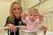 16 September 2013; Galway captain Lorraine Ryan with 13-month-old Zoe Garry, from Ballinteer, Dublin, and the O'Duffy Cup on a visit by the All-Ireland Senior & Intermediate Camogie Champions to Our Lady's Children's Hospital, Crumlin. Picture credit: Stephen McCarthy / SPORTSFILE
