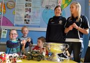 16 September 2013; Galway intermediate camogie captain Sinéad Keane and senior star Niamh Kilkenny in the company of children, from left, Tommy Whelan, age 5, from Ballon, Co. Carlow, James Lord, age 6, from Crossdoney, Co. Cavan, and Sam Carroll, age 3, from Stamullen, Co. Meath, and the O'Duffy Cup on a visit by the All-Ireland Senior & Intermediate Camogie Champions to Our Lady's Children's Hospital, Crumlin. Picture credit: Stephen McCarthy / SPORTSFILE