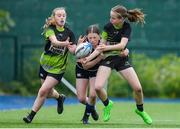 4 May 2024; Caoimhe Murphy of Portdara passes the ball to team-mate Matilda Pearson as she is tackled by Grace Carty of Wexford Wanderers during the Leinster Rugby Bank of Ireland Girls Youth Finals Day match between Portdara and Wexford Wanderers at Energia Park in Dublin. Photo by Shauna Clinton/Sportsfile