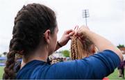 4 May 2024; Mullingar coach Jayne Charles ties a bow in the hair of player Caoimhe O'Mahony after the Leinster Rugby Bank of Ireland Girls Youth Finals Day match between Mullingar and Rhinos at Energia Park in Dublin. Photo by Shauna Clinton/Sportsfile