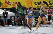 4 May 2024; Rhasidat Adeleke of Ireland, left, takes the baton from team-mate Sophie Becker whilst competing in the the women's 4x400m relay during day one of the World Athletics Relays at Thomas A Robinson National Stadium in Nassau, Bahamas. Photo by Erik van Leeuwen/Sportsfile