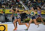 4 May 2024; Sharlene Mawdsley of Ireland, left, takes the baton from team-mate Phil Healy whilst competing in the women's 4x400m relay heats during day one of the World Athletics Relays at Thomas A Robinson National Stadium in Nassau, Bahamas. Photo by Erik van Leeuwen/Sportsfile