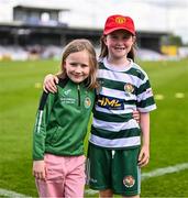 5 May 2024; Cockhill Celtic supporters, and cousins, Ava-Rose McLaughlin, age 8, and Macey McLaughlin, age 7, from Donegal, before the FAI Junior Cup final match between Cockhill Celtic and Gorey Rangers at Eamonn Deacy Park in Galway. Photo by Ben McShane/Sportsfile