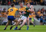 5 May 2024; Cillian Burke of Kerry in action against Darragh Bohannon and Alan Sweeney of Clare during the Munster GAA Football Senior Championship final match between Kerry and Clare at Cusack Park in Ennis, Clare. Photo by Brendan Moran/Sportsfile