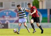5 May 2024; James Bradley of Cockhill Celtic in action against Gavin O'Brien of Gorey Rangers during the FAI Junior Cup final match between Cockhill Celtic and Gorey Rangers at Eamonn Deacy Park in Galway. Photo by Ben McShane/Sportsfile
