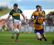5 May 2024; David Clifford of Kerry kicks a point despite the efforts of Ronan Lanigan of Clare during the Munster GAA Football Senior Championship final match between Kerry and Clare at Cusack Park in Ennis, Clare. Photo by Brendan Moran/Sportsfile