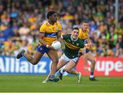 5 May 2024; Ikem Ugweru of Clare in action against Paudie Clifford of Kerry during the Munster GAA Football Senior Championship final match between Kerry and Clare at Cusack Park in Ennis, Clare. Photo by John Sheridan/Sportsfile