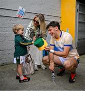 5 May 2024; David Clifford of Kerry is handed a Kerry hat by his son Ogie, watched by partner Shauna O'Connor, after the Munster GAA Football Senior Championship final match between Kerry and Clare at Cusack Park in Ennis, Clare. Photo by Brendan Moran/Sportsfile