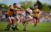 5 May 2024; Cillian Burke of Kerry is tackled by Gavin Murray and Brian McNamara of Clare during the Munster GAA Football Senior Championship final match between Kerry and Clare at Cusack Park in Ennis, Clare. Photo by Brendan Moran/Sportsfile