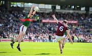 5 May 2024; John Daly of Galway has a kick blocked by Stephen Coen of Mayo during the Connacht GAA Football Senior Championship final match between Galway and Mayo at Pearse Stadium in Galway. Photo by Seb Daly/Sportsfile