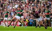 5 May 2024; Jordan Flynn of Mayo scores a point despite the challenge of John Daly of Galway during the Connacht GAA Football Senior Championship final match between Galway and Mayo at Pearse Stadium in Galway. Photo by Daire Brennan/Sportsfile