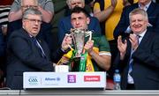 5 May 2024; Kerry captain Paudie Clifford is presented with the cup by Munster Council chairman Ger Ryan, left, in the company of Munster Council PRO Dermot Weeshie Lynch, after the Munster GAA Football Senior Championship final match between Kerry and Clare at Cusack Park in Ennis, Clare. Photo by Brendan Moran/Sportsfile