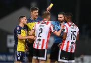6 May 2024; Ronan Boyce of Derry City is shown a yellow card by referee Paul McLaughlin during the SSE Airtricity Men's Premier Division match between Derry City and Shelbourne at The Ryan McBride Brandywell Stadium in Derry. Photo by Stephen McCarthy/Sportsfile