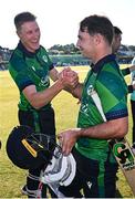 10 May 2024; Curtis Campher of Ireland, right, is congratulated by teammate Harry Tector after hitting the winning runs in their side's victory during match one of the Floki Men's T20 International Series between Ireland and Pakistan at Castle Avenue Cricket Ground in Dublin. Photo by Seb Daly/Sportsfile