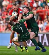 11 May 2024; RG Snyman of Munster is tackled by Conor Oliver and Peter Dooley of Connacht during the United Rugby Championship match between Munster and Connacht at Thomond Park in Limerick. Photo by Brendan Moran/Sportsfile
