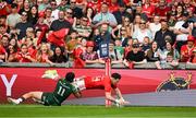 11 May 2024; Calvin Nash of Munster scores his side's second try despite te tackle of Byron Ralston of Connacht during the United Rugby Championship match between Munster and Connacht at Thomond Park in Limerick. Photo by Brendan Moran/Sportsfile