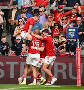 11 May 2024; Munster players, from left, Craig Casey, Simon Zebo and Alex Nankivell celebrate with teammate Calvin Nash, after he scored their side's second try during the United Rugby Championship match between Munster and Connacht at Thomond Park in Limerick. Photo by Brendan Moran/Sportsfile