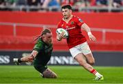 11 May 2024; Calvin Nash of Munster beats the tackle of Finlay Bealham of Connacht during the United Rugby Championship match between Munster and Connacht at Thomond Park in Limerick. Photo by Brendan Moran/Sportsfile
