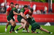 11 May 2024; Shane Daly of Munster is tackled by Cathal Forde and Shane Jennings of Connacht during the United Rugby Championship match between Munster and Connacht at Thomond Park in Limerick. Photo by Brendan Moran/Sportsfile