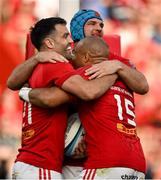 11 May 2024; Conor Murray of Munster, left, celebrates with teammates Tadhg Beirne and Simon Zebo after scoring their side's fourth try during the United Rugby Championship match between Munster and Connacht at Thomond Park in Limerick. Photo by Brendan Moran/Sportsfile