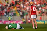 11 May 2024; Kyle Hayes of Limerick falls to the ground,while Declan Dalton of Cork watches on during the Munster GAA Hurling Senior Championship Round 3 match between Cork and Limerick at SuperValu Páirc Ui Chaoimh in Cork. Photo by Daire Brennan/Sportsfile