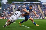 11 May 2024; Jordan Larmour of Leinster evades the tackle of Keelan Giles of Ospreys on his way to scoring his side's fifth try during the United Rugby Championship match between Leinster and Ospreys at the RDS Arena in Dublin. Photo by Ben McShane/Sportsfile