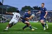 11 May 2024; Jordan Larmour of Leinster gets past the tackle of Keelan Giles of Ospreys on his way to scoring his side's eighth try during the United Rugby Championship match between Leinster and Ospreys at the RDS Arena in Dublin. Photo by Ben McShane/Sportsfile
