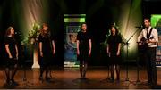 11 May 2024; The CLG Bhaile na Maor team, including Claire Guinan, Eimear Guilfoyle, Síle Reynolds, Sarah Buggy and Ciarán Mac Raghnaill, representing Offaly and Leinster in the Bailéad-Ghrúpa competition during the Scór Sinsear 2024 All-Ireland Finals at the INEC Arena in Killarney, Kerry. Photo by Shauna Clinton/Sportsfile
