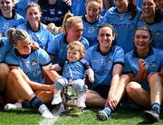 12 May 2024; Dublin players including Carla Rowe and Hannah Tyrrell, with her daughter Aoife, celebrate with the Mary Ramsbottom Cup after their side's victory in the Leinster LGFA Senior Football Championship final match between Dublin and Meath at Croke Park in Dublin. Photo by Harry Murphy/Sportsfile