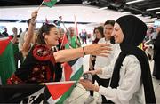 12 May 2024; Dina Abdeen of Palestine is greeted by Michelle Hayes, from Tipperary, on arrival at Dublin Airport as the Palestine women's national football team arrive in Ireland for an International Solidarity Match against Bohemians to be played on Wednesday at Dalymount Park in Dublin. Photo by Stephen McCarthy/Sportsfile