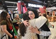 12 May 2024; Dina Abdeen of Palestine embraces a team-mate on arrival at Dublin Airport as the Palestine women's national football team arrive in Ireland for an International Solidarity Match against Bohemians to be played on Wednesday at Dalymount Park in Dublin. Photo by Stephen McCarthy/Sportsfile