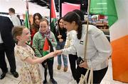 12 May 2024; Charlotte Phillips of Palestine is greeted by Robyn Keoghan, left, and Eloise Knox, both aged 10, from Dublin, on arrival at Dublin Airport as the Palestine women's national football team arrive in Ireland for an International Solidarity Match against Bohemians to be played on Wednesday at Dalymount Park in Dublin. Photo by Stephen McCarthy/Sportsfile
