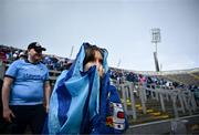 12 May 2024; Dublin supporter Ciara Jordan uses a flag to cover from the rain the Leinster GAA Football Senior Championship final match between Dublin and Louth at Croke Park in Dublin. Photo by Harry Murphy/Sportsfile