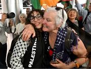 12 May 2024; Sara Kord of Palestine is greeted by Bríd Smith TD on arrival at Dublin Airport as the Palestine women's national football team arrive in Ireland for an International Solidarity Match against Bohemians to be played on Wednesday at Dalymount Park in Dublin. Photo by Stephen McCarthy/Sportsfile